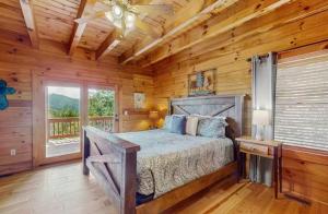 a bedroom with a bed in a log cabin at 4 Bed 4 Bath Vacation home in Sylva in Sylva +24 photos