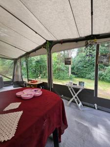 a tent with a table with plates of food on it at Radbjerg privat camping in Væggerløse +25 photos