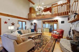a living room with a couch and a fireplace at Merrywoode in Lake Toxaway