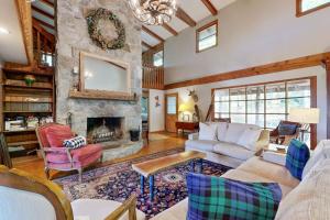 a large living room with a stone fireplace at Merrywoode in Lake Toxaway +19 photos