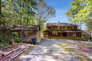 a house with a driveway next to a building at Merrywoode in Lake Toxaway