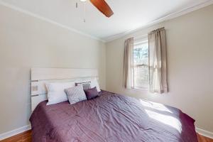 a bedroom with a large bed with a window at Lake Emory Gem in Franklin