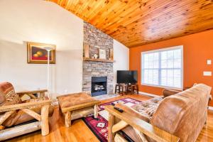 a living room with a couch and a fireplace at Trimont Mountain Cottage in Franklin