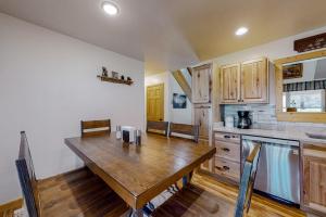 a kitchen with a wooden table and a counter top at The Mountain Haven in Maggie Valley
