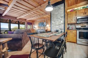 a kitchen and living room with a table and chairs at Black Bear Cabin Fox Mountain in Franklin