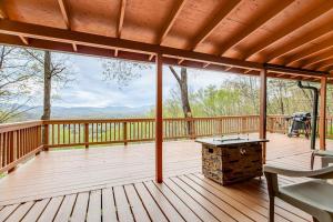a large deck with a bench and a table on it at Black Bear Cabin Fox Mountain in Franklin