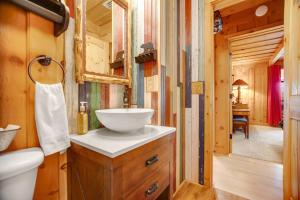 a bathroom with a sink and a toilet in a log cabin at Black Bear Cabin Fox Mountain in Franklin +38 photos