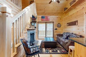 a living room with a couch and a fireplace at Whispering Pines in Murphy
