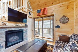 a living room with a fireplace and a tv at Whispering Pines in Murphy