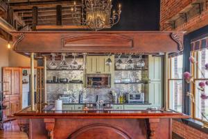 a kitchen with a large wooden bar in a room at Brick Loft Penthouse on Main in Brevard