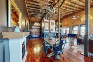 a kitchen and dining room with a table and chairs at Brick Loft Penthouse on Main in Brevard