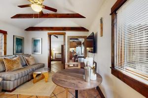 a living room with a couch and a table at Main Street Wood Cottage in Brevard