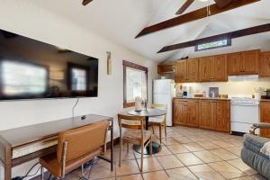 a kitchen with a table and a dining room at Main Street Wood Cottage in Brevard +8 photos