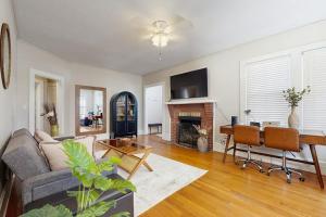a living room with a couch and a table at Main Street Brick Cottage in Brevard