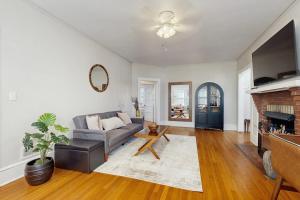 a living room with a couch and a fireplace at Main Street Brick Cottage in Brevard