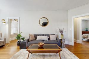 a living room with a couch and a table at Main Street Brick Cottage in Brevard