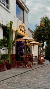 a group of tables and umbrellas outside of a store at Il Riposo in Arequipa