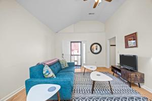 a living room with a blue couch and a tv at Hominy Creek Haven in Candler