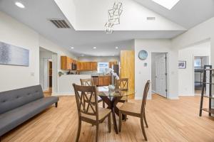 a dining room and living room with a table and chairs at Hominy Creek Haven in Candler