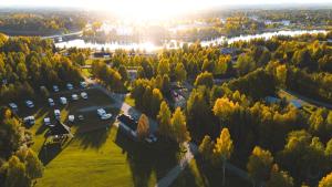an aerial view of a park with trees and a river at Nilimella Camping & Resort in Sodankylä