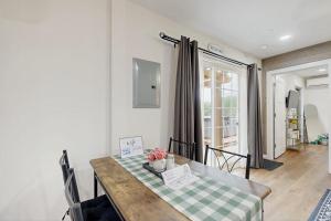 a dining room with a table with a green and white checkered table cloth at Gibbs Getaway in Leicester
