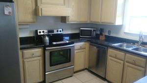 a kitchen with a stove top oven next to a sink at Relaxing comfort house nice equiped in Pharr