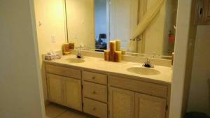 a bathroom with two sinks and a large mirror at Relaxing comfort house nice equiped in Pharr +41 photos
