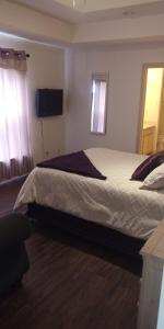 a bedroom with a bed and a television on the wall at Relaxing comfort house nice equiped in Pharr