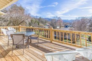 a wooden deck with a table and chairs on it at The Willows in Waynesville