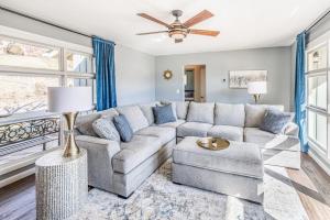a living room with a couch and a ceiling fan at The Willows in Waynesville