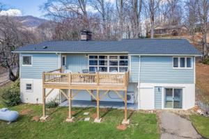 a house with a large deck in the yard at The Willows in Waynesville +22 photos