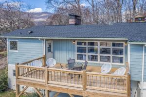 a house with a deck with chairs and a table at The Willows in Waynesville