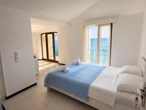 a bedroom with a bed and a large window at Sunny Beach Hotel in Kobuleti