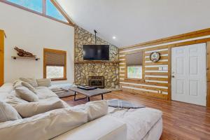 a living room with a couch and a fireplace at Pebble on The Creek in Whittier