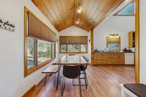 a kitchen and dining room with a table and chairs at Pebble on The Creek in Whittier