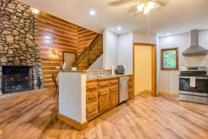 a kitchen with a fireplace and a stone wall at Close to Heaven in Sylva +20 photos