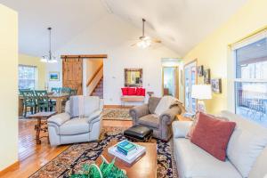 a living room with two chairs and a couch at Tree Top Cabin in Sylva +20 photos