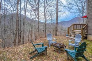 a group of chairs and a table on a porch at Tree Top Cabin in Sylva