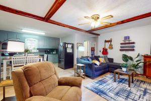 a living room with a couch and a kitchen at Elk Valley Lodge in Maggie Valley