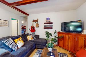 a living room with a couch and a flat screen tv at Elk Valley Lodge in Maggie Valley