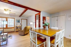 a dining room and living room with a table and chairs at Elk Valley Lodge in Maggie Valley +18 photos