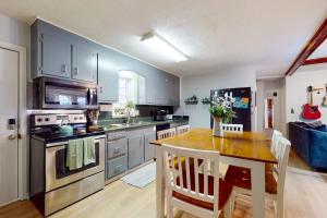 a kitchen with a wooden table and a kitchen with a stove at Elk Valley Lodge in Maggie Valley