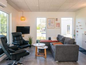 a living room with a couch and two chairs at 4 star holiday home in Ringkøbing in Ringkøbing