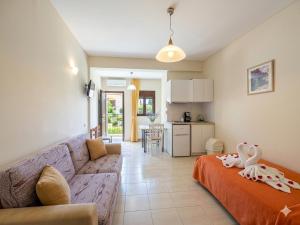 a living room with a couch and a kitchen at Ta Kalamakia Apartments in Vatera
