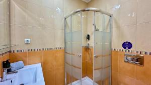 a shower with a glass door in a bathroom at Liberdade - Near the beach - 6 Pax - Albufeira in Albufeira