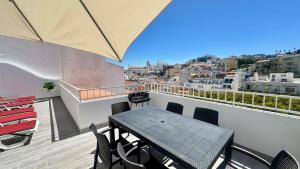 a table and chairs on a balcony with a view at Liberdade - Near the beach - 6 Pax - Albufeira in Albufeira +19 photos