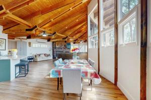 a dining room with a table and a kitchen at Red Fox Lair in Franklin