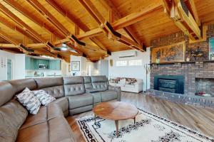 a living room with a couch and a fireplace at Red Fox Lair in Franklin