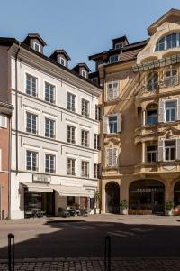 a group of buildings next to a street at Rennweg 114 BELAMI LIVING in Merano
