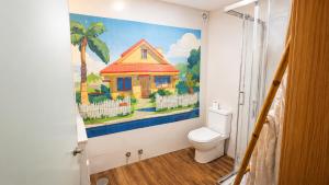 a bathroom with a painting of a house on the wall at Atlantic Spot Guest House in Praia de Mira +104 photos
